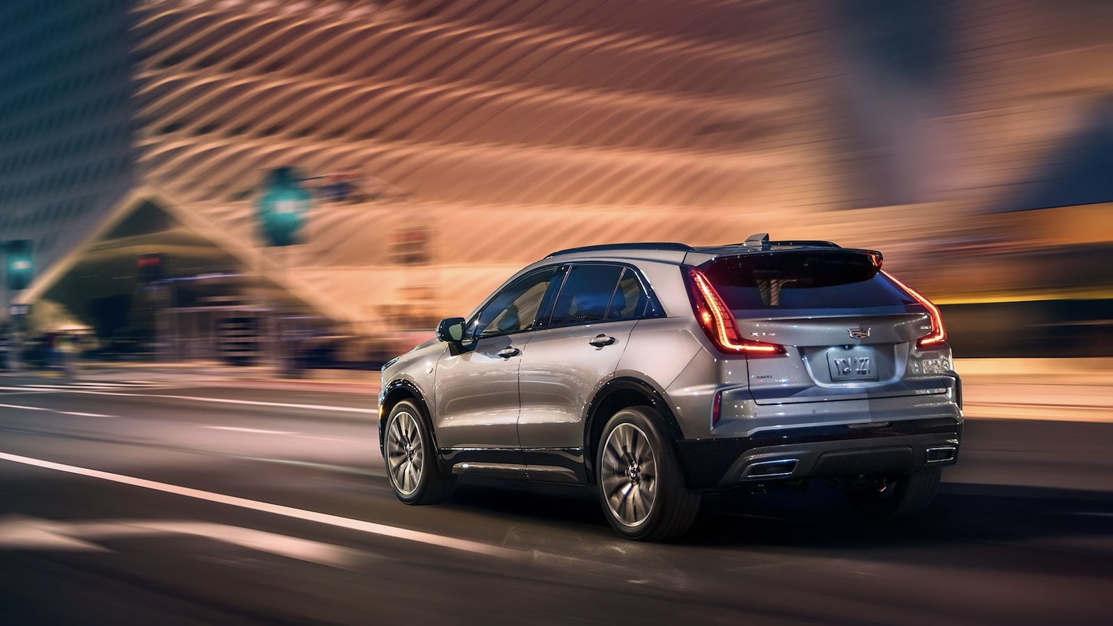 The Cadillac XT4 2025 on a city road at night.
