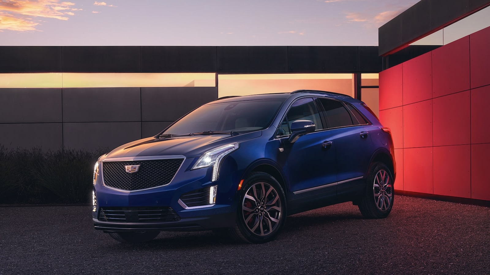 The Cadillac XT5 2025 parked in the driveway of a residence.