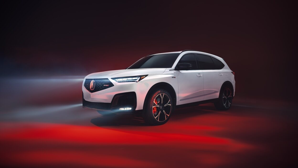 White 2025 Acura MDX, luxury SUV with LED headlights and red accents, dark ambiance.