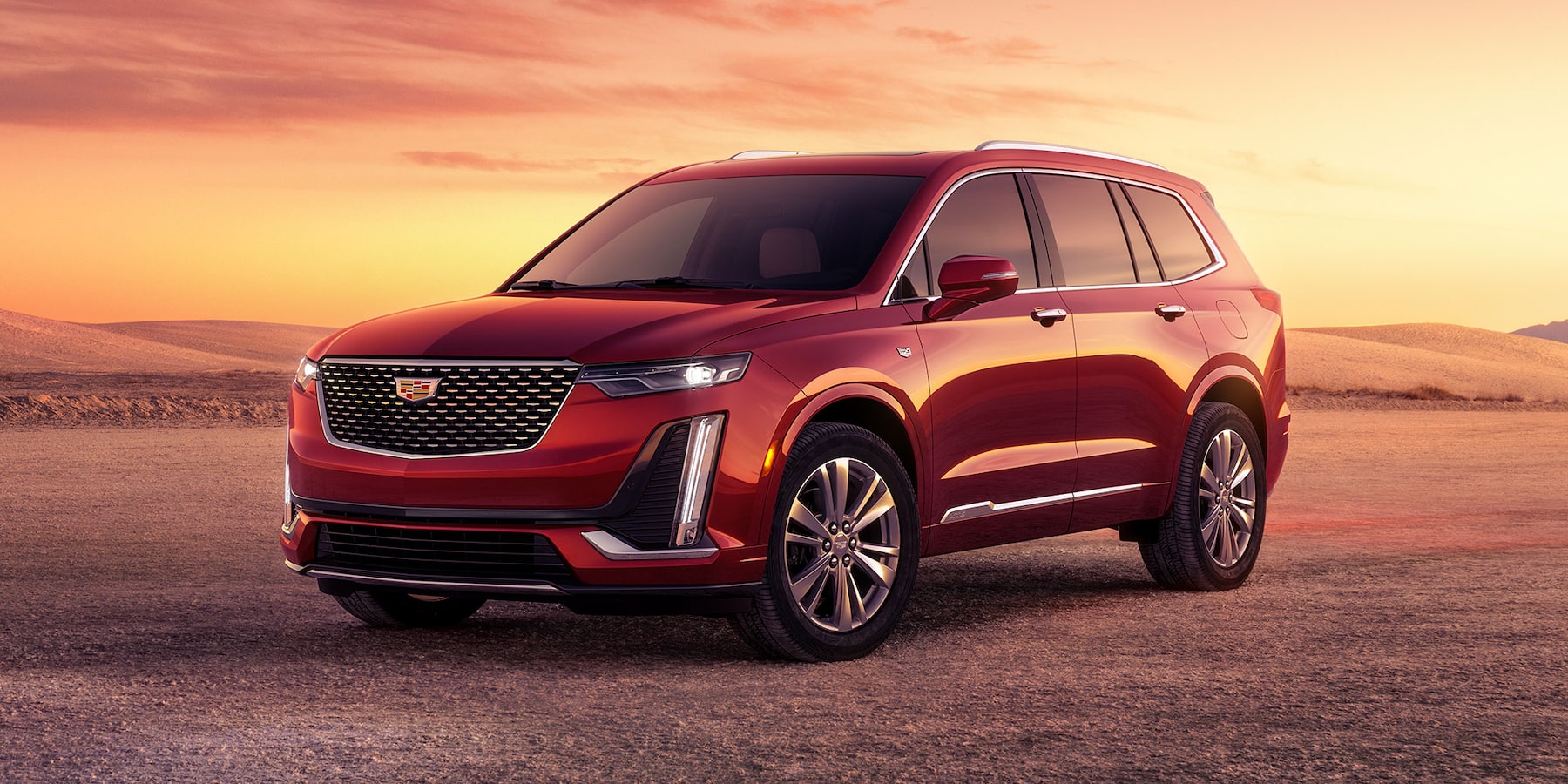 2025 Cadillac XT6 front view on a rocky plain during sunrise